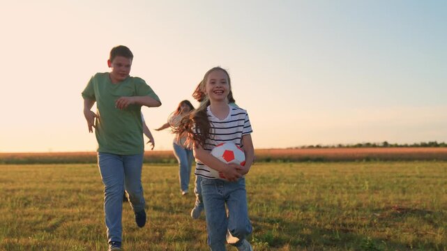 Parents run with child kid playing ball green lawn, children game ball, mother father girl boy happy run family sunset, sky backdrop, cheerful friends running and laughing with soccer ball, kids