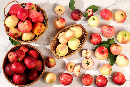 Assortment of apple varieties in a basket on concrete table, Thanksgiving background, concept of healthy,natural eating and the harvest, banner for cafes and restaurants, detox diet and body cleansing