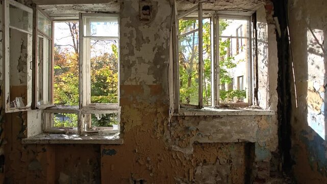 A worn-out room with a window and a sink, suggesting a humble or impoverished setting