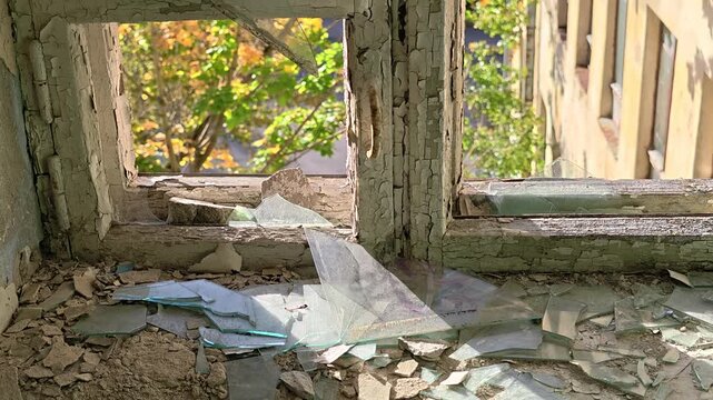 A broken window in a deteriorated building