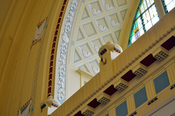 Art nouveau arched interior and stained glass window at prague train station with geometric ceiling panels for architectural banner and interior design background © iri.madrid.art