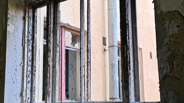A broken window in a deteriorated building