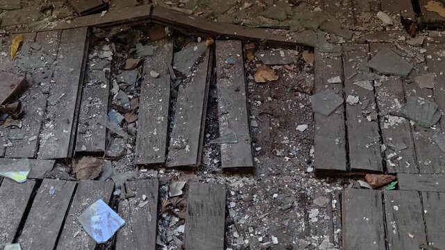A pile of broken wood sits on the floor, ready for disposal or reuse