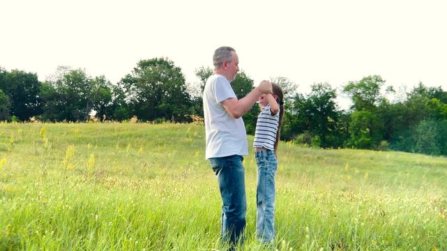 happy family, children dream fun fly, kid with father playing outdoors, Togetherness in the great outdoors, sunny day in the meadow, father supporting his child, plants and trees surround, being