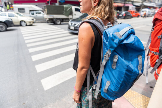 Traveler waiting at urban crosswalk.