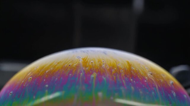 Colour bands sliding on a soap film