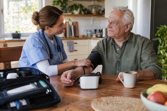 Home Care Nurse Measuring Blood Pressure of Elderly Man