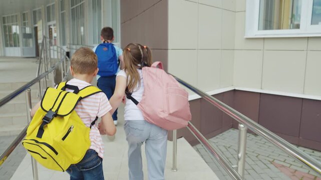 Group of kids with bags, Ready for school success, Learning with friends, Morning at primary school, Colorful backpacks ready, Excitement for new knowledge, Safe and happy entry, Positive start to