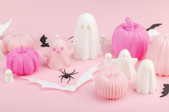 Pink Halloween flat lay with pastel pumpkins, cute ghosts, paper bats, and black spiders
