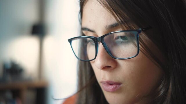 Close-up shot of a young female student&rsquo;s face, deeply focused while reading. Concept of concentration, education, learning, academic study, knowledge, and student life, with an emphasis on focus and 