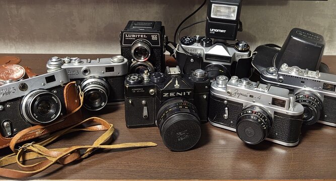 Vintage camera collection displayed on a wooden shelf.November 30, 2025. Belarus. Vitebsk.