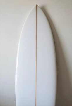 Surfing lifestyle and summer vacation, white surfboard with wooden stringer leaning against a neutral wall for water sports and ocean recreation equipment