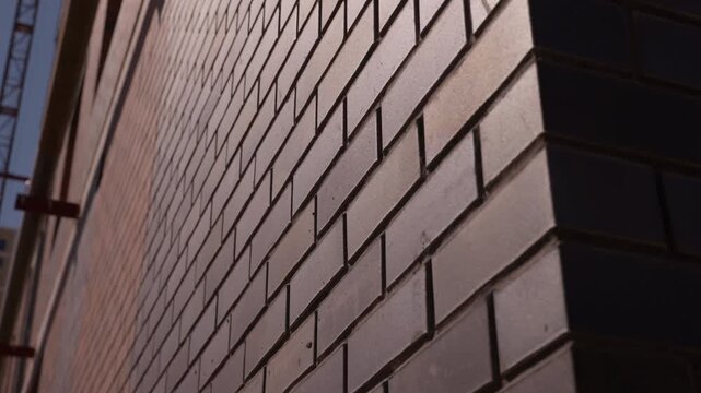 Close up of brick wall corner with sunlight and shadow