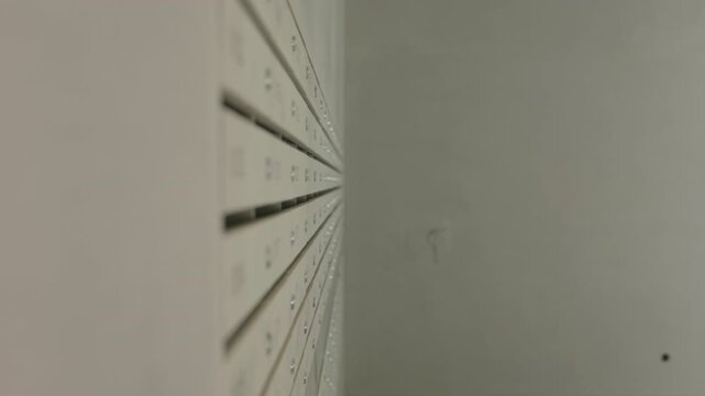 Numbered metal mailboxes installed in modern apartment building
