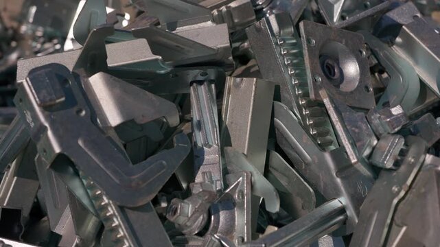 Pile of metal formwork clamps and fastening components for construction
