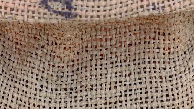 Smooth transition from woven burlap sack texture to rich roasted coffee beans inside. Filmed at a food festival in Spain. Ideal for coffee marketing, cafe promotion, and food documentaries.