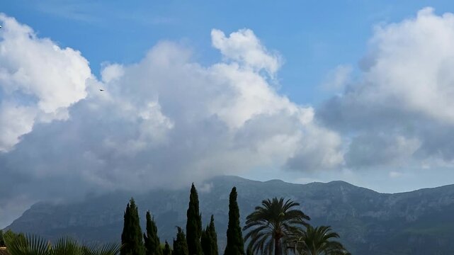 Timelapse of thick clouds gradually dissipating and evaporating over Montgo mountain summit in Denia, Spain. Perfect for weather changes, nature documentaries, and atmospheric background.