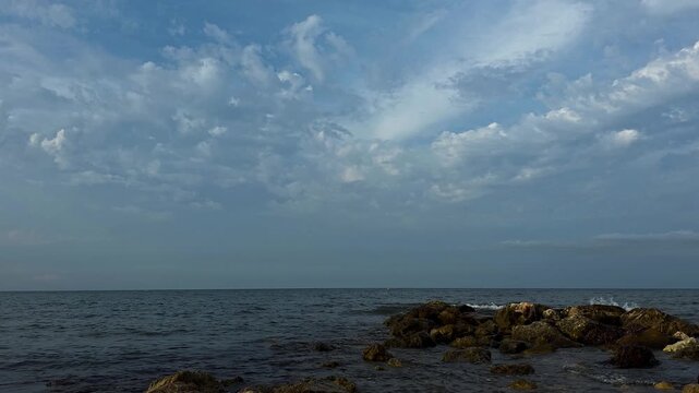 Timelapse of pre-rain clouds moving fast in different directions due to wind shear over the Mediterranean sea in Spain. Ideal for weather science, meteorology, and dynamic background.