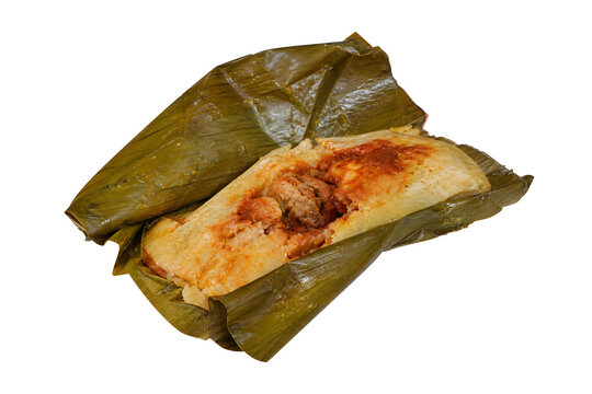 Guatemalan pache potato tamal partly opened from integral banana leaf Isolated on White Background
