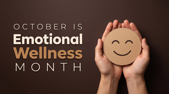 Hands holding a cardboard smiley face for Emotional Wellness Month awareness