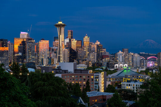 SEATTLE, WASHINGTON, USA - MONTH DAY, YEAR: The Seattle skyline and the Space Needle at dusk with Mount Rainier in the distance, seen from Kerry Park.