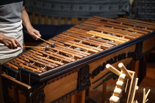Hands playing a wooden marimba in Guatemala