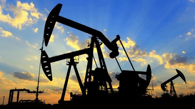 Oil Rig With Moving Cloud Background. Oil drilling derricks at desert oilfield. Crude oil production from the ground.