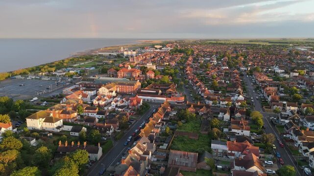 Sunset bathes seaside town in warm, golden light