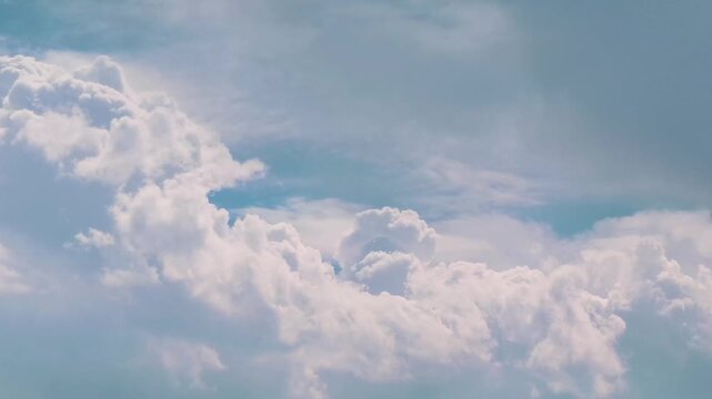 Fluffy white cumulus clouds against a blue sky