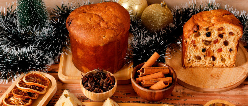 Slices of classic panettone showing delicate dough, candied fruit in a festive Christmas arrangement.