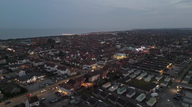 Dusk settles over coastal town with scattered lights