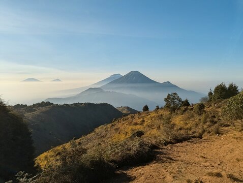 Breathtaking view of Mount Sindoro and Mount Sumbing volcanoes above the clouds in Central Java Indonesia