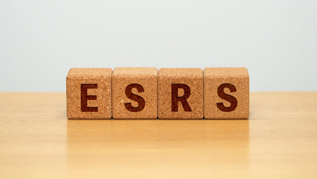 ESRS on four cork wooden blocks - European Sustainability Reporting Standards concept