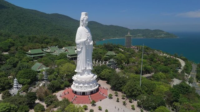 Gazing out over the ocean, the towering white Lady Buddha statue