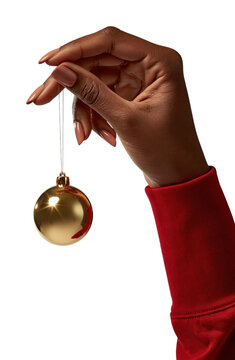 PNG Black female hand holding a gold Christmas ornament on white background