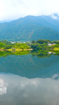 Emerald Blue Pond Reflection of Mountains and Sky at Ikeda Pond Niihama Ehime Japan