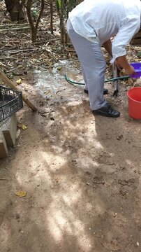 Young Man Washing Hands With Clean Water After Bathing Puppy