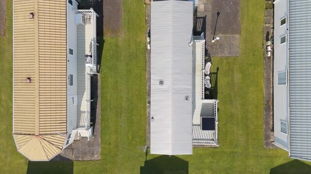 Aerial view of three modular homes in a tidy row