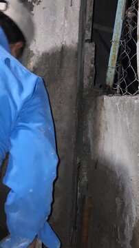 Inserting Trowel With Cement Mortar Into Wall Void