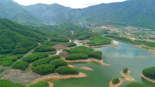 Serene drone glide over lush islands dotting a calm reservoir