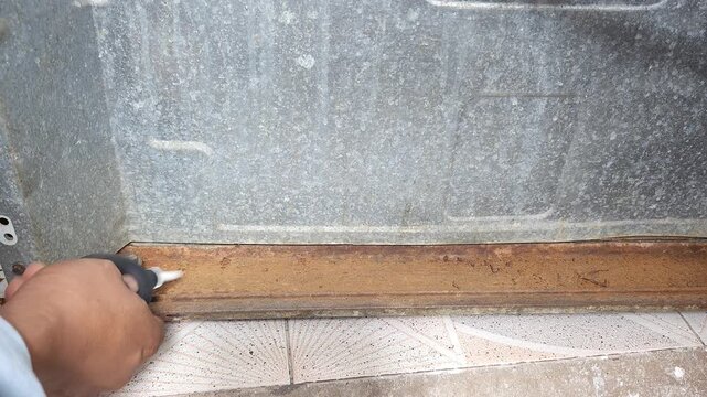 Blowing Away Dust And Rust Debris Off Stove Surface Using Air Blower Squeezer