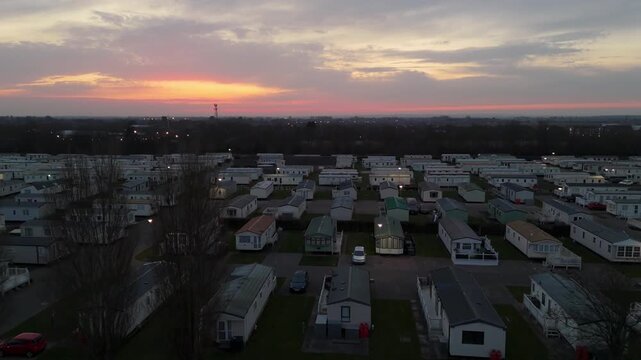 Sunset lights glow over quiet mobile home park