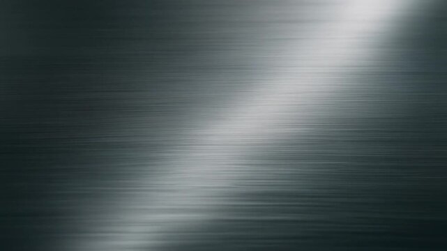 Brushed silver metal texture background with diagonal light reflection and industrial polished steel surface for design