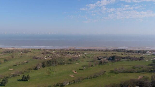 Aerial view over coastal golf course and ocean