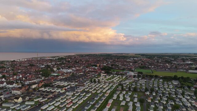 Aerial view shows a coastal town at sunset