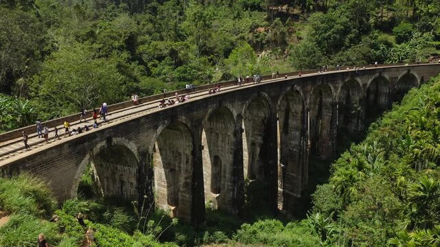 Nine Arches Bridge in Sri Lanka with Tourists Walking Across Under Sun