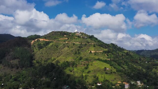 White Pagoda Temple on a Green Mountain Summit in Sri Lanka Aerial