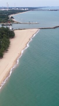Aerial View of Sandy Beach and Coastline with Breakwater