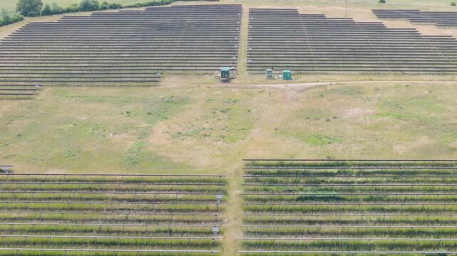 Aerial view of solar panels in a green field