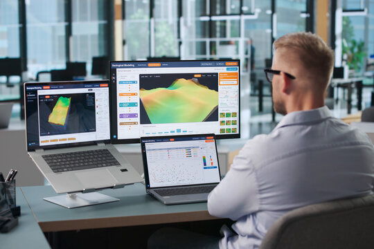Geologist Studies 3D Subsurface Data Using Laptop